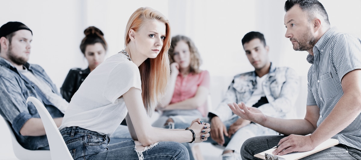 Young women getting questioned for her honesty in addiction treatment and recovery