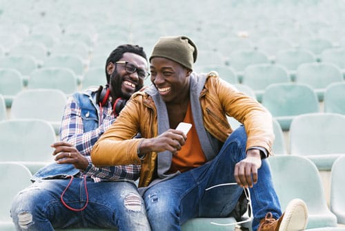 Two young male smiling showing positive results from Family therapy