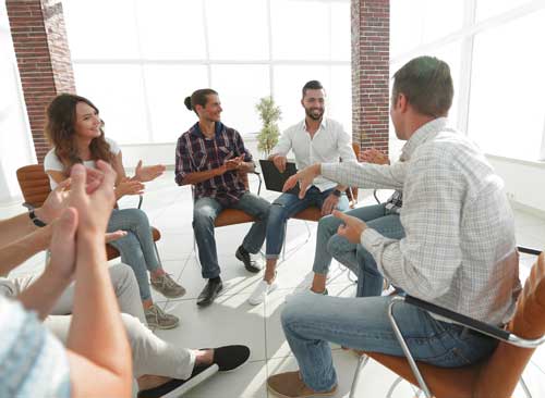 Group of people having Substance Abuse Group Counseling Session with a therapist
